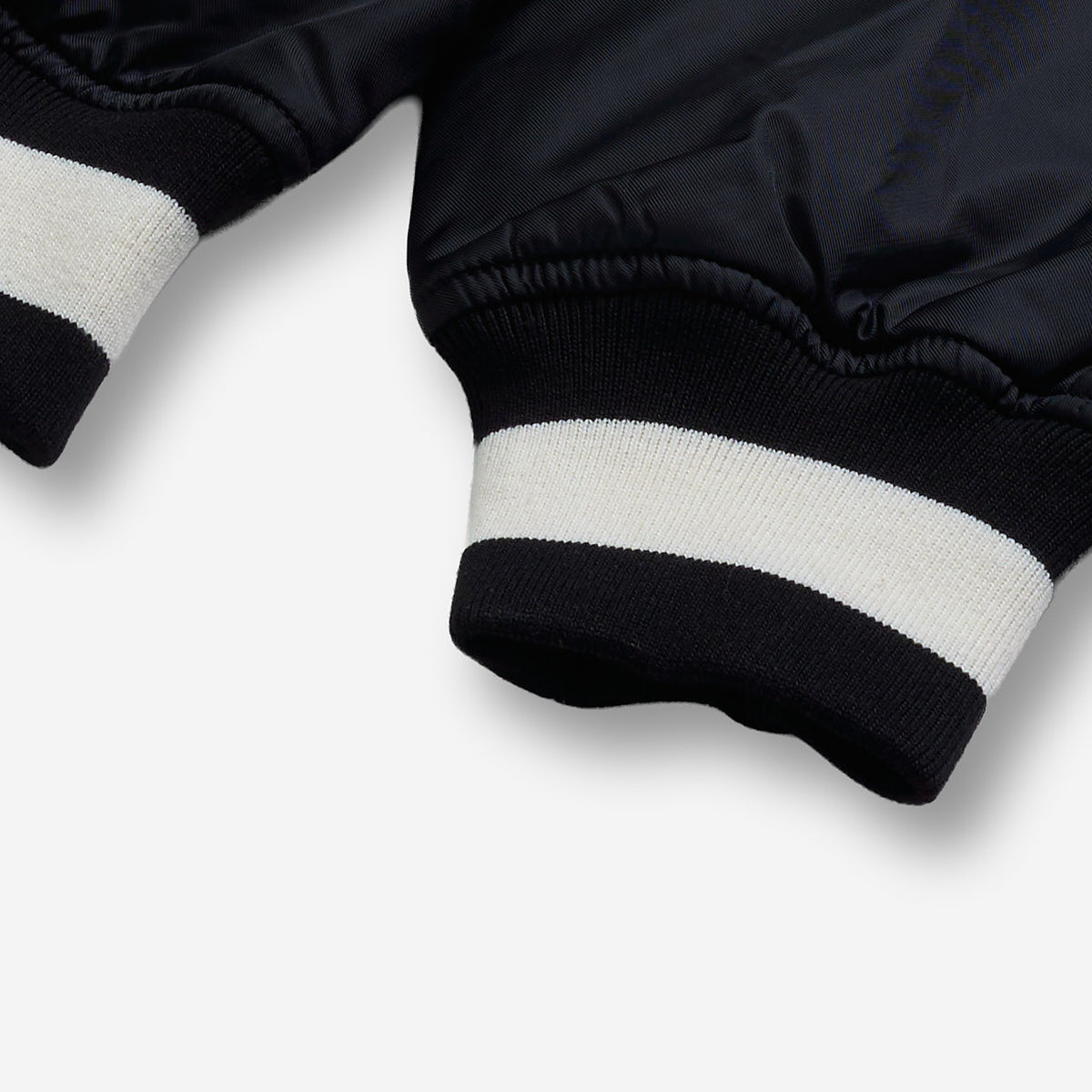 AlphaStyle Barren Varsity Jacket in Black – Detailaufnahme der Ärmelbündchen mit schwarz-weißem Rippstrick