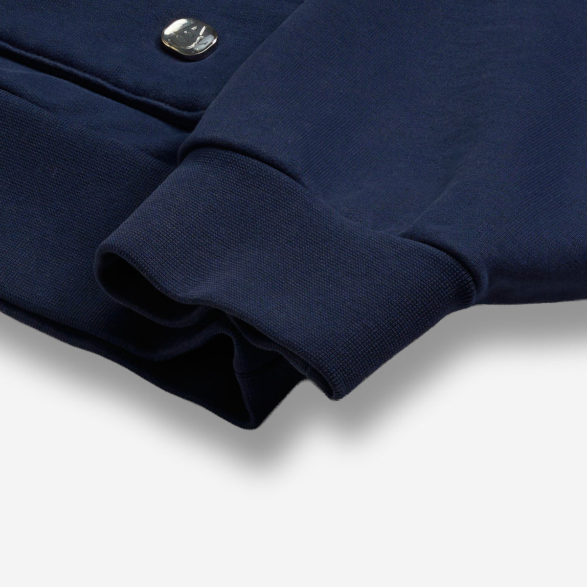 AlphaStyle United Hood Hoodie in Navy – Detailaufnahme des Ärmelbündchens mit Metall-Logo-Badge