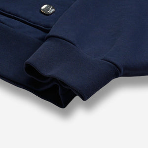 AlphaStyle United Hood Hoodie in Navy – Detailaufnahme des Ärmelbündchens mit Metall-Logo-Badge