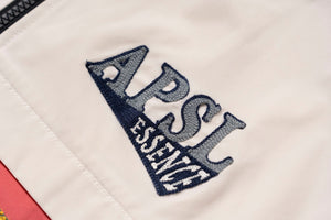 AlphaStyle Whitman Batwing Windbreaker Jacket – Detailansicht der gestickten APSL-Essence-Applikation in Navy auf Bone